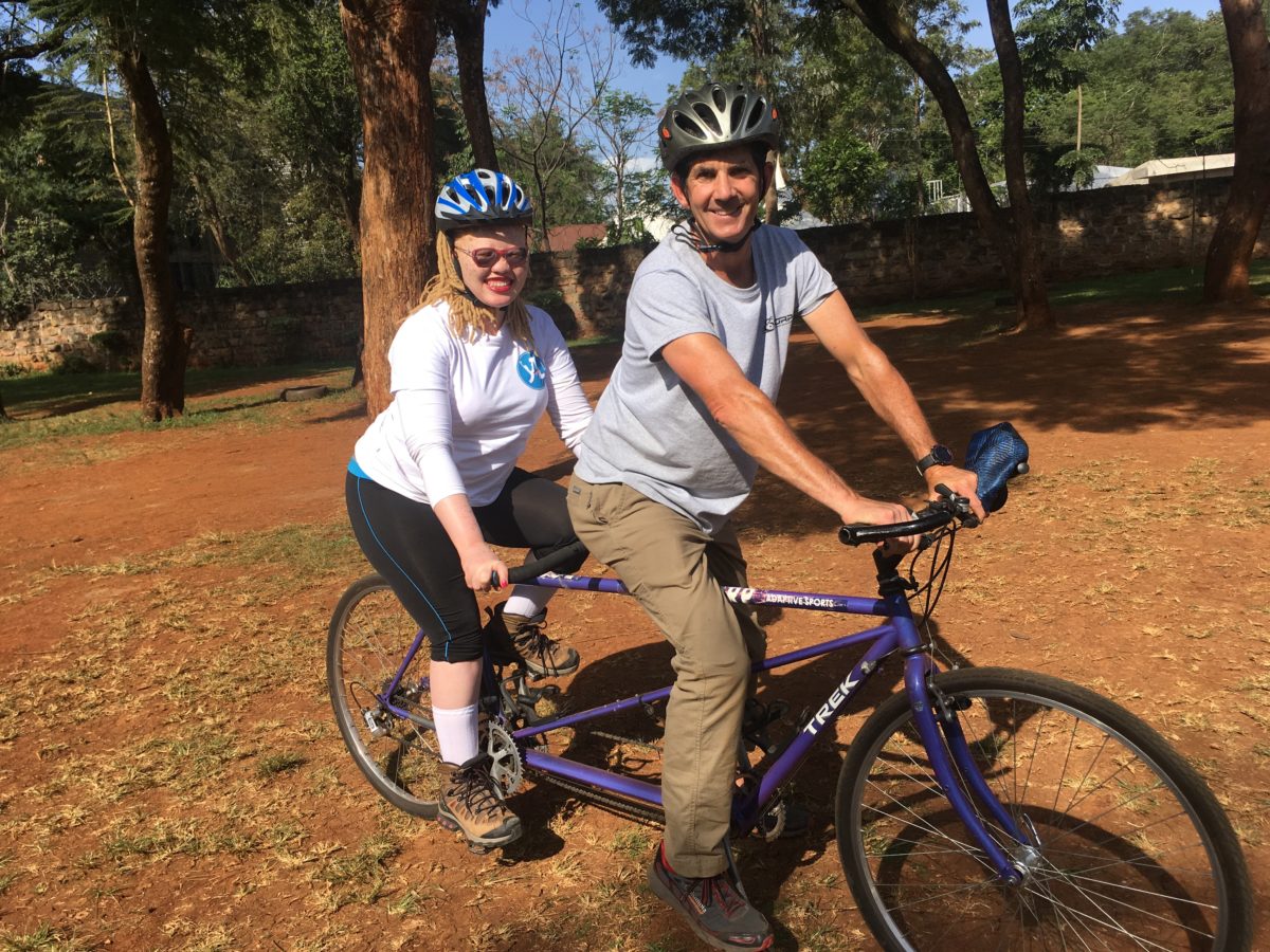 An RE Awardee and Fellow ride a bicycle.