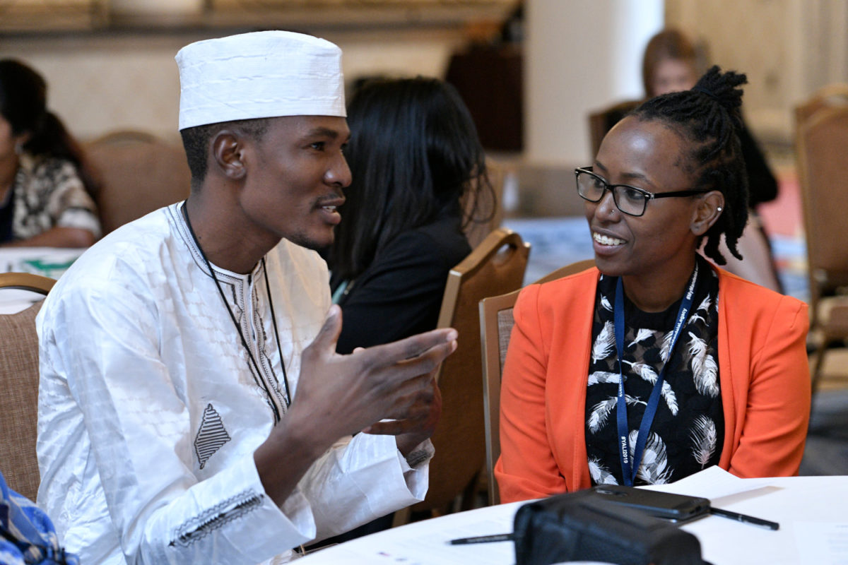 Two Fellows conversing during the 2019 Summit.