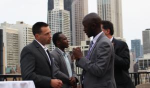 A Fellow and potential partner converse during a networking event.