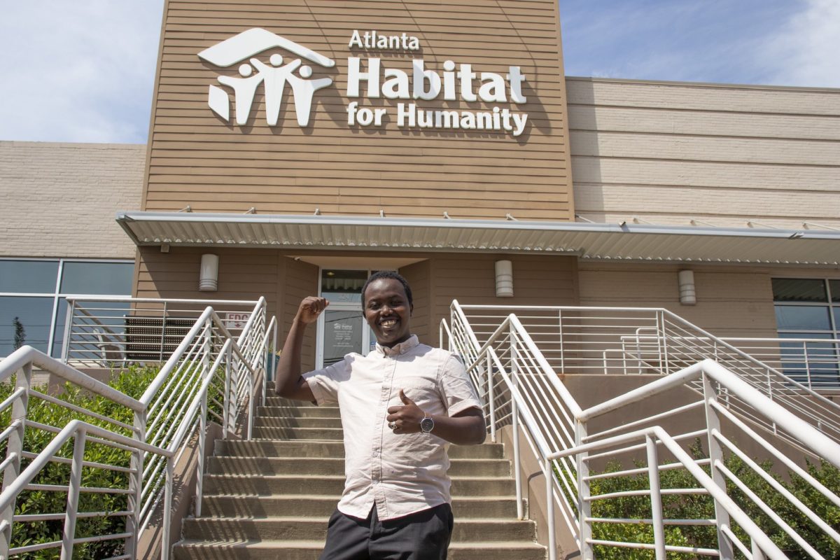 2019 Fellow Aboubaker Tourab poses in front of Atlanta Habitat for Humanity, where he completed his Professional Development Experience.