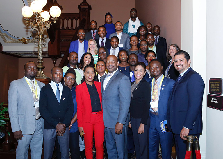 2016 Mandela Washington Fellow Beatrice Muthoni Ngugi and her Fellow colleagues pictured standing with California Senator Isadore Hall III at the California State Capitol in Sacramento.