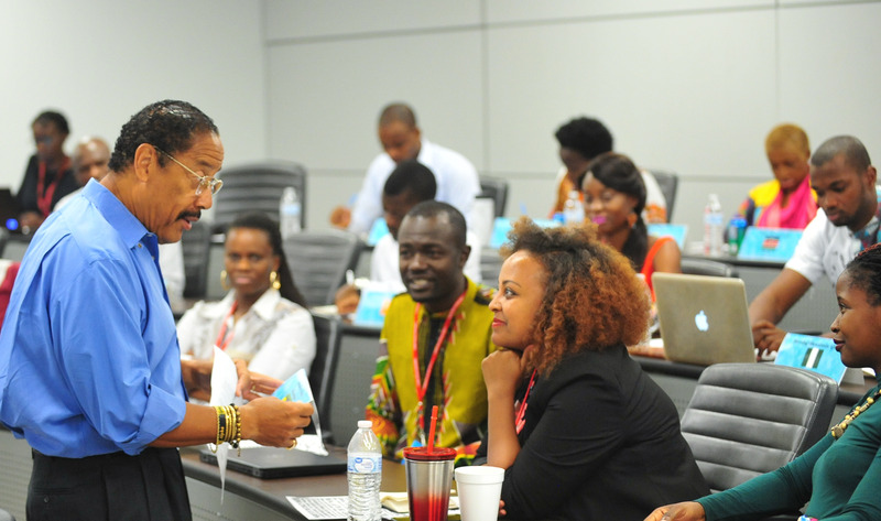 Fellows listen to a lecture at Clark Atlanta University in an ampitheather-style classroom.