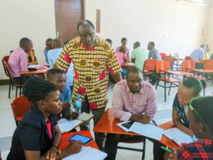 2019 Awardee Jesse Lutabingwa from Appalachian State University follows up with a discussion from participants during the group work assignment a workshop in Tanzania.