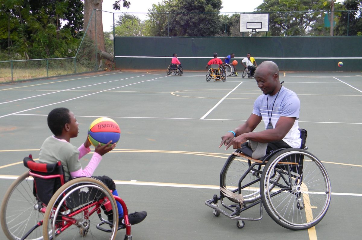 2016 Fellow Nyasha Mharakurwa plays wheelchair basketball with a beneficiary during Sarah Olson's 2017 Reciprocal Exchange to Zimbabwe.