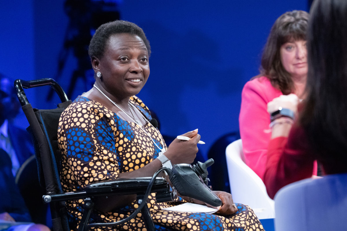 Lois Auta, Nigerian woman in wheelchair, speaks on stage on a panel