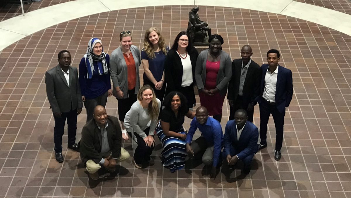 A group of people pose for a photo in an atrium