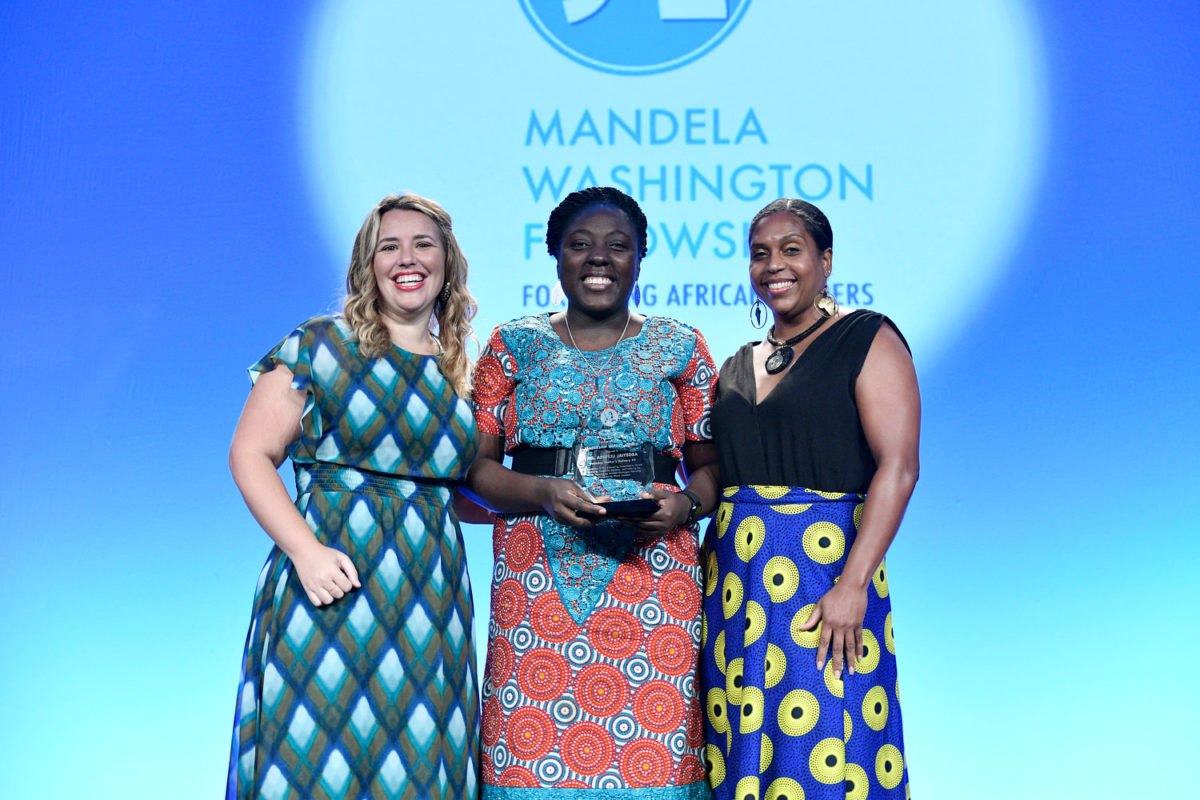 Three women standing shoulder-to-shoulder in front of the Mandela Washington Fellowship