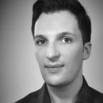 Black and white headshot of a man with short hair