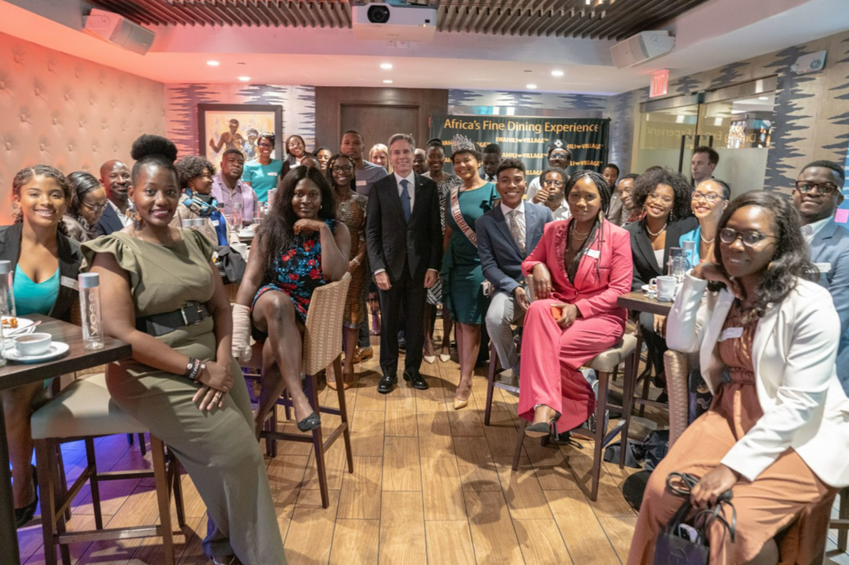 Group photo; some people stand and others are seated