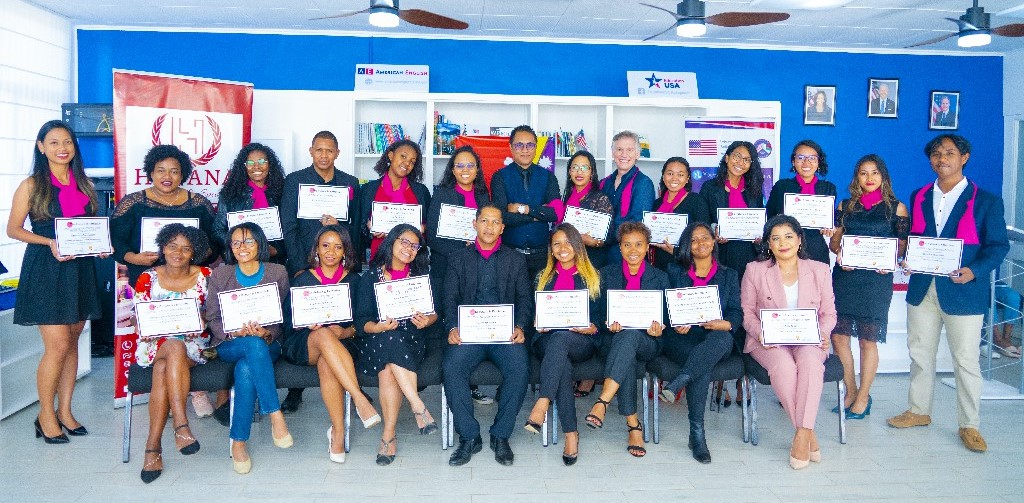 Group of people pose for a photo holding certificates